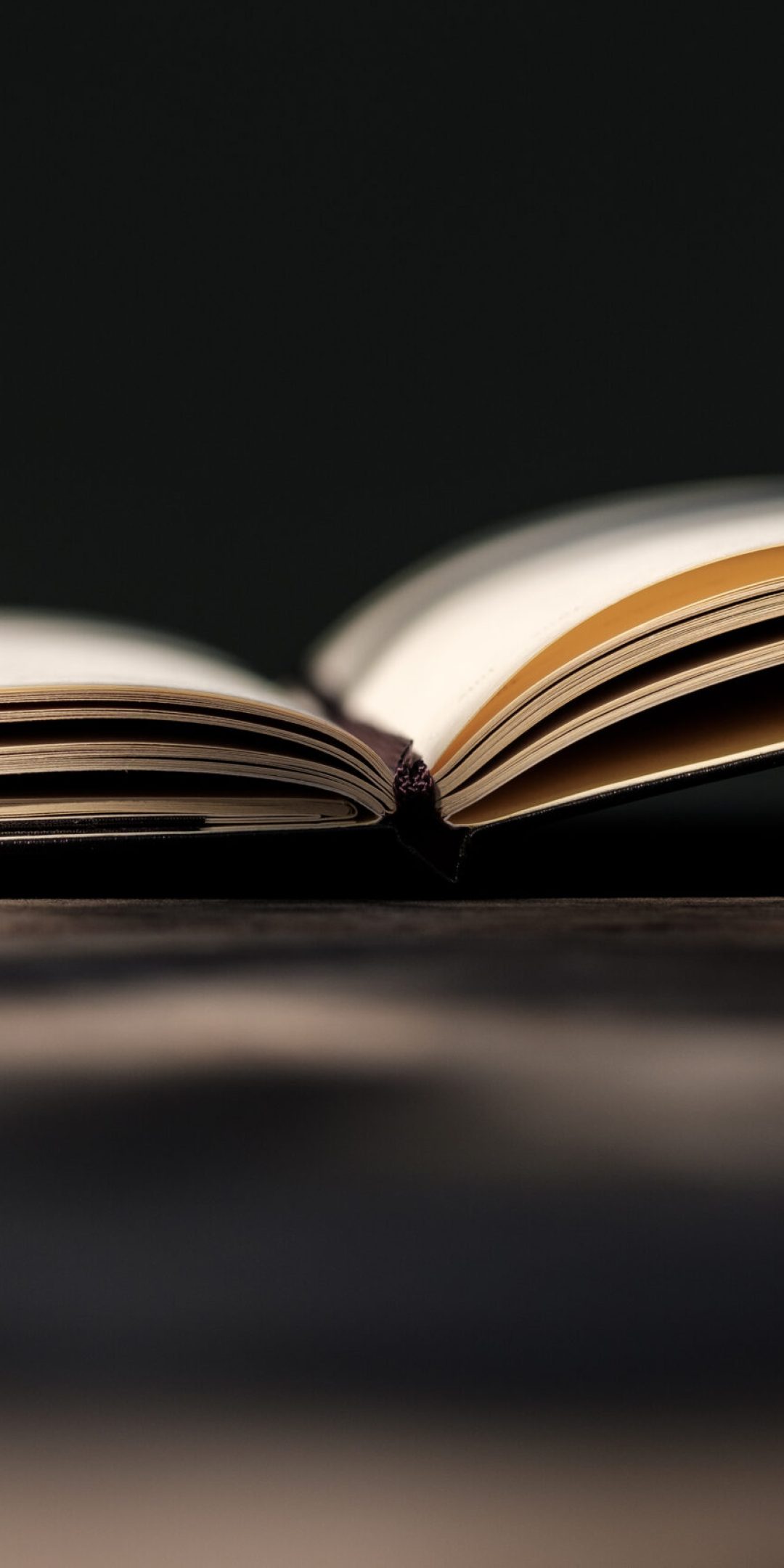 Simple image of a notebook book on a wood table outdoors. Side view with bokeh. Old fashioned, imagination, creativity concept.